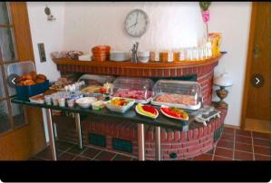 a fireplace with a bunch of food on a table at Pension Haus Norddeich Mole in Norddeich
