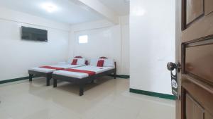 a bedroom with a bed with red and white pillows at RedDoorz @ Western Bicutan Transients Inn in Manila