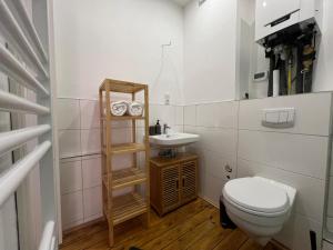 a small bathroom with a toilet and a sink at Villa Högemann in Wilhelmshaven