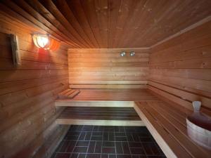 a wooden sauna with a bench in the middle at Landhaus up de Warft - Backhaus in Werdum