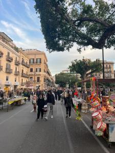 a group of people walking down a city street at Casa di Paola in Palermo