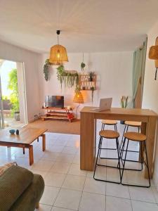 a living room with a table with a laptop on it at Villa accès port plage à pied sanary sur mer in Sanary-sur-Mer