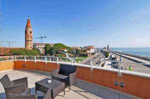 a balcony with chairs and a view of the ocean at Bellavista in Caorle