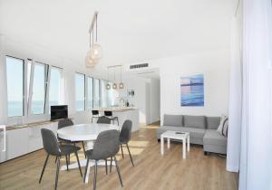 a living room with a table and chairs and a couch at Bellavista in Caorle