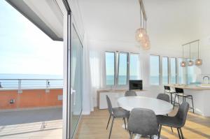 a dining room and kitchen with a table and chairs at Bellavista in Caorle +9 photos