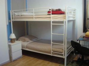 a bedroom with a bunk bed and a desk at CREW KEY WEST in Antibes