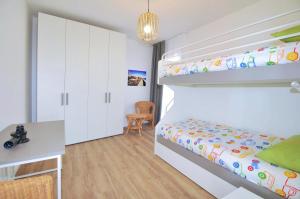 a bedroom with a bunk bed and a desk at Bellavista in Caorle