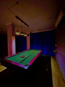 a ping pong table in a dark room with avertisement at Hamilton Hotel & Resort Goa in Goa