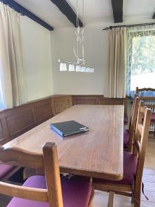 a dining room table with a book on top of it at Schwarzwaldhaus Sonnenstraße, Oberried-Hofsgrund, Dreisamtal in Oberried