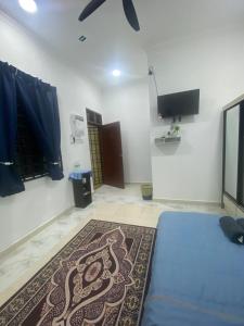 a room with a bed and a rug on the floor at KZ Roomstay in Kuala Terengganu