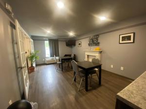 a living room with a table and chairs and a fireplace at Savannah Suites Atlanta Airport in Atlanta