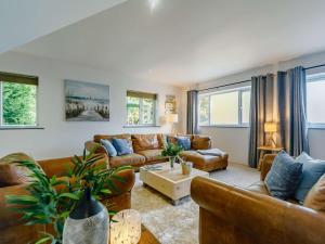 sala de estar con ventanas y muebles de cuero marrón en 3 Bed in Portreath 89492 en Camborne