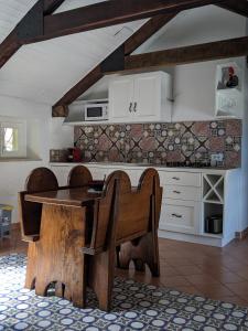 a kitchen with a wooden table and some chairs at Casa Giovanna Positano in Positano