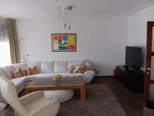 a living room with a white couch and a coffee table at Villa Lake in Konjic