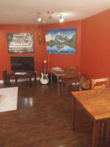a living room with orange walls and a table at Apartment in House on Main Level in Mississauga