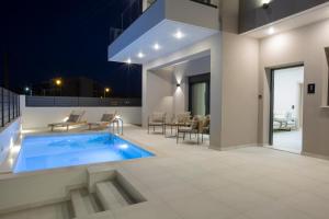 a swimming pool on the roof of a house at Pomaria Boutique Residences in Lefkada Town