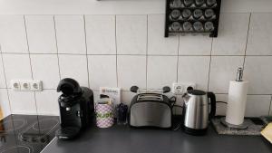 a kitchen counter top with a coffee maker and appliances at Zum Kleingarten Leipzig in Leipzig