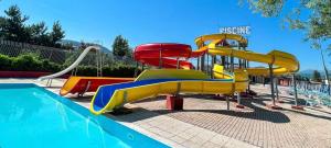 a water slide in a park with a pool at Star house in Forlì del Sannio
