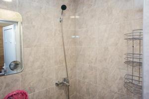 a bathroom with a shower with a glass door at Turnovo Smart Studio - Cozy Work & Relax in Veliko Tŭrnovo +55 photos