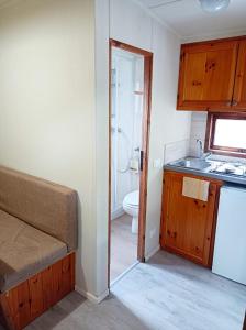 a small bathroom with a sink and a toilet at Il Frantoio Camping in San Bartolomeo al Mare