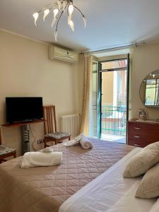 a bedroom with a large bed with towels on it at Il Siciliano Apartment Taormina in Taormina
