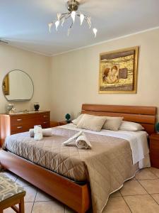 a bedroom with a large bed and a mirror at Il Siciliano Apartment Taormina in Taormina