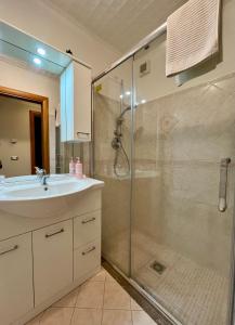 a bathroom with a glass shower and a sink at Il Siciliano Apartment Taormina in Taormina