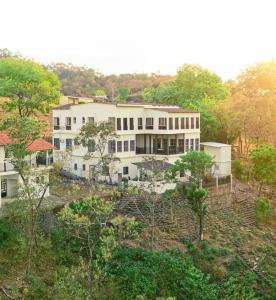 a large white building in the middle of a forest at Breathtaking Mountain Views in La Union, El Salvador in La Unión