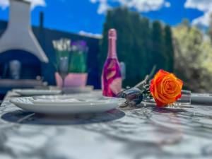 a table with a plate and a flower on it at Apartment Sova or Deluxe room 33 in Bled +34 photos