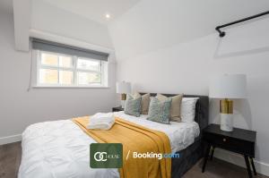 a white bedroom with a bed and a window at Elegant 2 Bed Harbour Front Flat By OC House Short Lets & Serviced Accommodation Gillingham, Ramsgate, Folkestone With Balcony in Kent