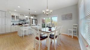 a kitchen and dining room with a table and chairs at Charming Cottage Prime Location 3BR in South Haven