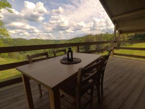 a table and chairs on a deck with a view at Glamping Podere Poggiagrilli in San Gervasio