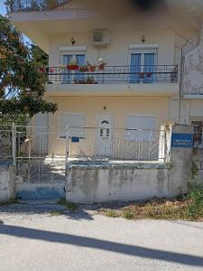 a house with a gate and a balcony at Machouse in Mytilini