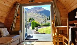 a door leading to a deck with a mountain view at Bothan Creag Sobhrag in Ballachulish