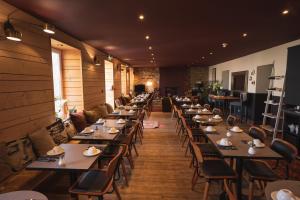 a row of tables and chairs in a restaurant at Ty Mad Hôtel in Groix