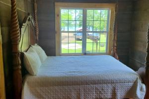 a bedroom with a bed and a window at Back in time 1940s Lakeview House in South Toledo Bend