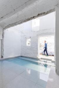 a person walking in a room with a swimming pool at Casa cristo 37 navarrés in Navarrés