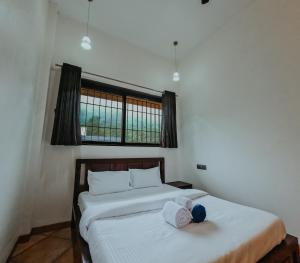 a bedroom with two beds with towels on them at BREEZE THE HILLS in Trimbak