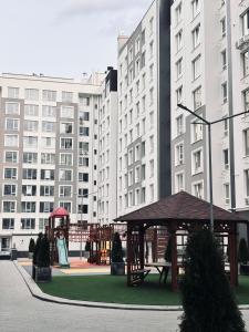 a gazebo in a city with tall buildings at Milescu Residence in Chişinău +6 photos