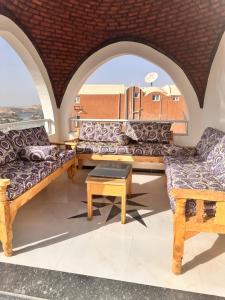 a room with two couches and a table at Basha house in Aswan