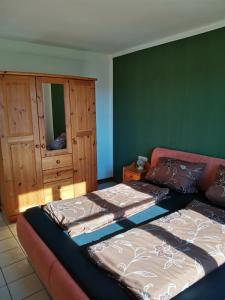 a living room with two beds and a cabinet at Zum Gänseglück in Reut