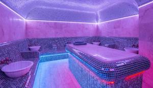Baño de color rosa con bañera y lavamanos en Katalina SPA Resort en Tsigov Chark