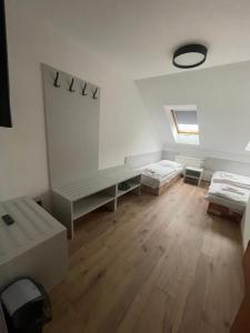 a room with two beds and a wooden floor at HOTEL ZELENÝ DVOR in Senec