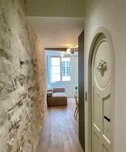 um corredor com uma porta branca e um sofá em Appartement hyper centre 2 chambres em Baiona