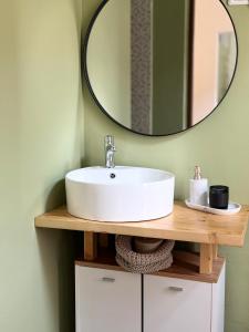 a bathroom with a sink and a mirror at Central - Cozy Studio in Arad