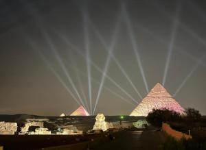 a view of the pyramids of giza at night at Pyramids station View in Cairo