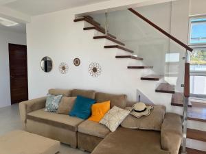 a living room with a couch and a staircase at Casa Amores: Camaya Coast in Mariveles