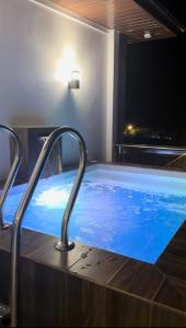 a large hot tub in a hotel room with at Casa Amores: Camaya Coast in Mariveles