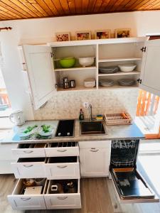 a kitchen with white cabinets and a sink at Apartma Lip in Rateče