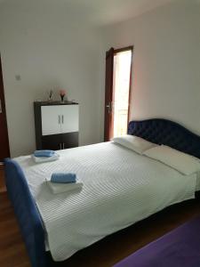 a bedroom with a large bed with two towels on it at Aki in Drvar